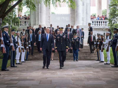 President Donald Trump leaves after attending a Memorial Day ceremony at Arlington National Cemetery in Arlington, Virginia, May 28, 2017. Two military aides carrying two “nuclear footballs” can be seen walking behind and to the right of Trump.