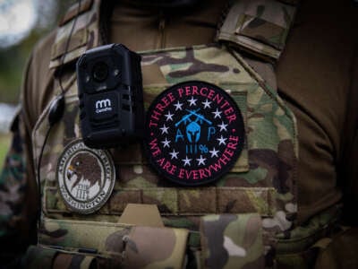 A man wears a patch of the "American Patriots Three Percent" (R) militia as several hundred members of the Proud Boys and other similar groups gathered for a rally at Delta Park in Portland, Oregon, on September 26, 2020.