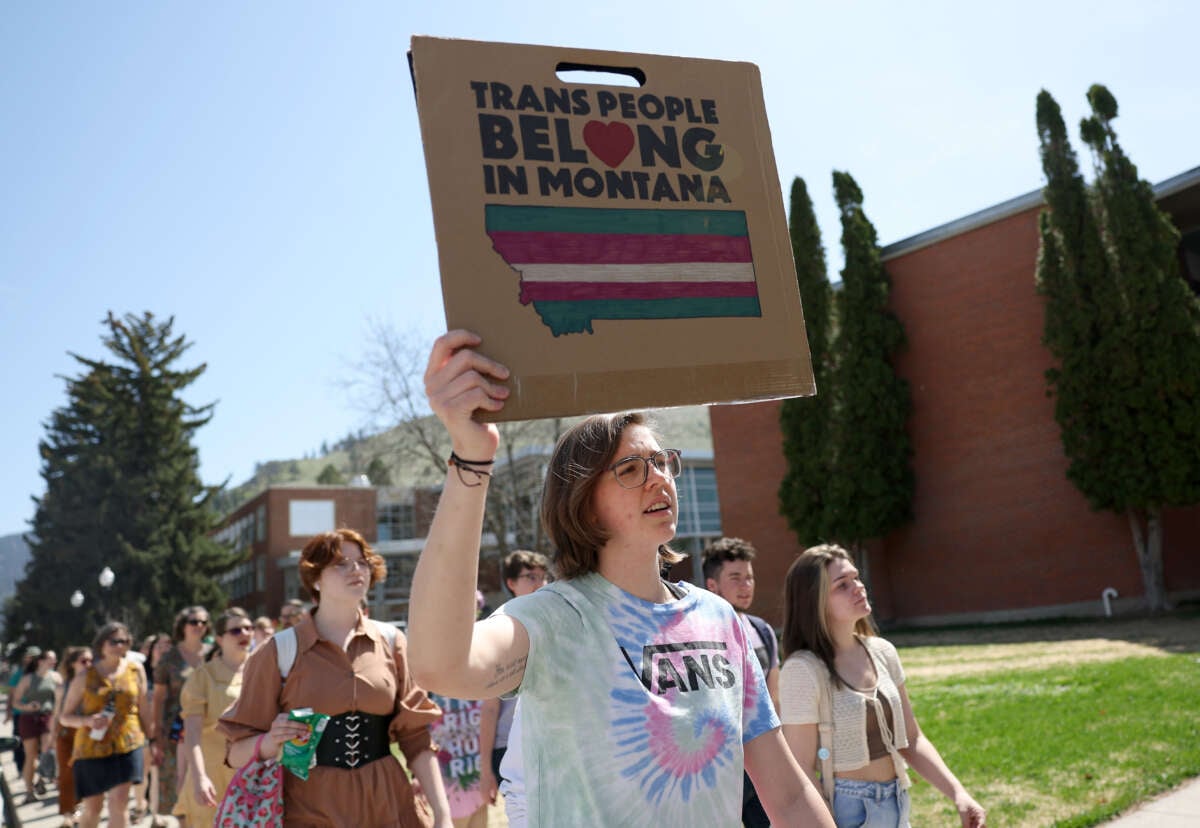 Transgender rights activists hold signs as they march through the University of Montana campus on May 03, 2023 in Missoula, Montana.