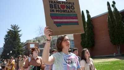 Transgender rights activists hold signs as they march through the University of Montana campus on May 03, 2023 in Missoula, Montana.