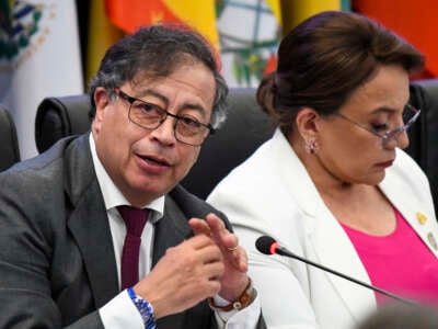 Colombia's President Gustavo Petro (L) speaks next to Honduras's President Xiomara Castro during the CELAC Summit in Buccament Bay, Saint Vincent and the Grenadines, on March 1, 2024.