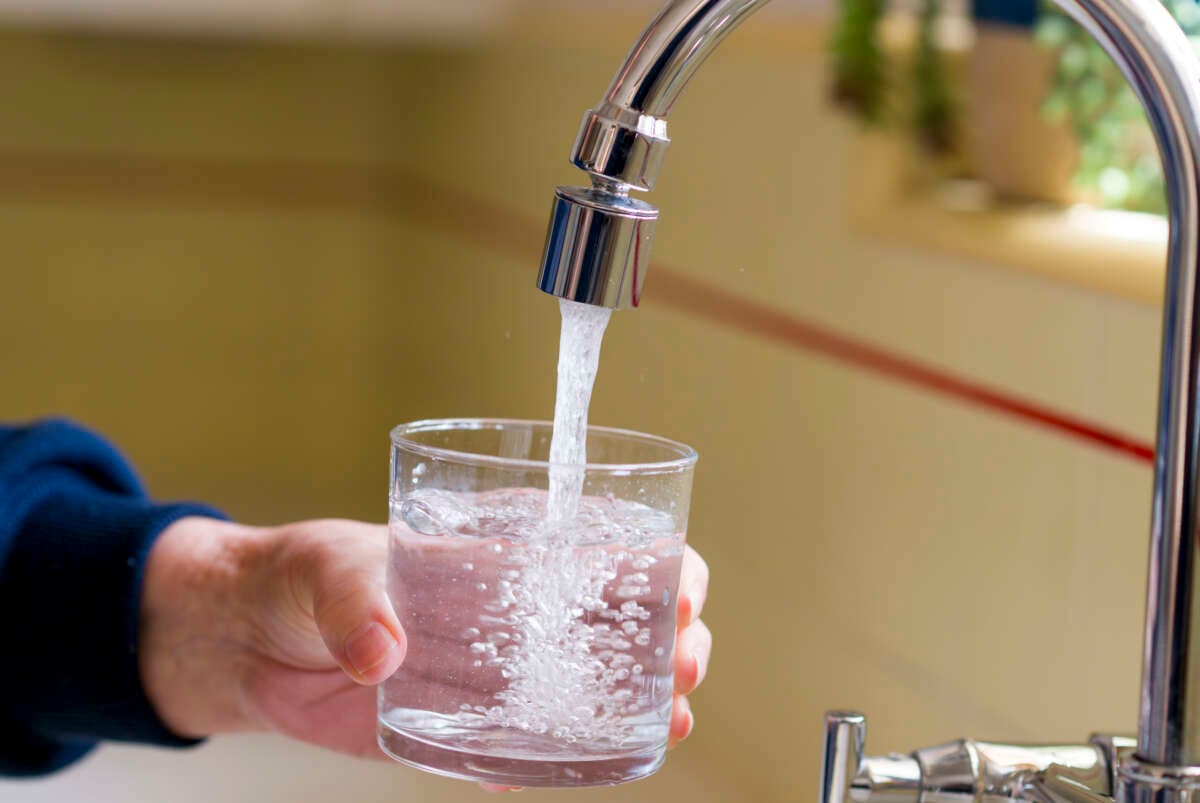 A glass of water is poured from a kitchen faucet in Santa Ana, California, on April 26, 2024.