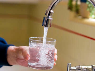 A glass of water is poured from a kitchen faucet in Santa Ana, California, on April 26, 2024.