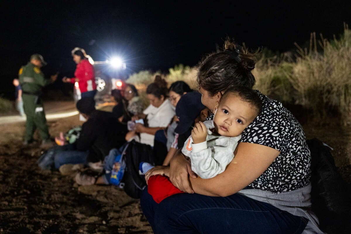 Migrants are processed by U.S. Border Patrol agents after crossing into the U.S. from Mexico through an abandoned railroad on June 24, 2024, in Jacumba Hot Springs, San Diego, California.