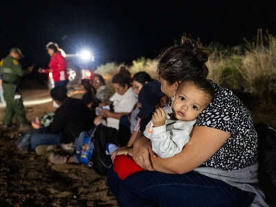 Migrants are processed by U.S. Border Patrol agents after crossing into the U.S. from Mexico through an abandoned railroad on June 24, 2024, in Jacumba Hot Springs, San Diego, California.