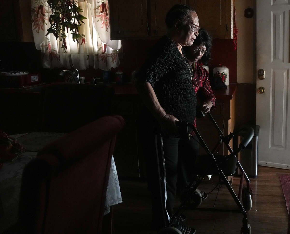 Liz Kindle helps her mom, Enola Zenon, out of her home in the Kashmere Gardens neighborhood on July 16, 2024 in Houston, Texas.