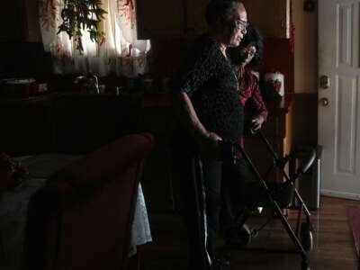 Liz Kindle helps her mom, Enola Zenon, out of her home in the Kashmere Gardens neighborhood on July 16, 2024 in Houston, Texas.