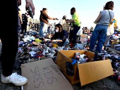 Thousands of people pick up clothes, foods, toiletries during a wild fire relief for victims pop up of Eaton Fire at Santa Anita Park in Arcadia, California, on January 11, 2025. Keith Birmingham / MediaNews Group / Pasadena Star-News via Getty Images