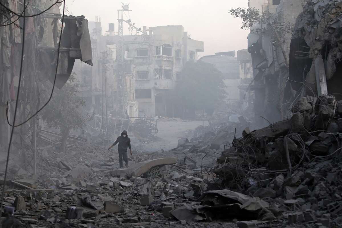 A man walks through the rubble of buildings destroyed by Israeli airstrikes at the Bureij camp for Palestinian refugees in the central Gaza Strip on January 12, 2025.