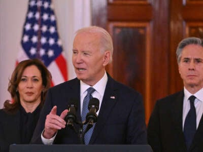 President Joe Biden, flanked by Vice President Kamala Harris and Secretary of State Antony Blinken, speaks about the Israel-Hamas ceasefire and hostage release deal in the Cross Hall of the White House on January 15, 2025.