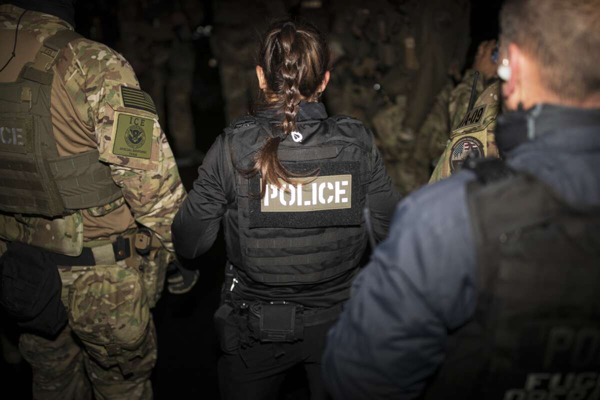 Immigration and Customs Enforcement Special Response Team agents gather for a team meeting in a parking lot in Alexandria, Virginia, on October 4, 2022.