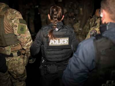 Immigration and Customs Enforcement Special Response Team agents gather for a team meeting in a parking lot in Alexandria, Virginia, on October 4, 2022.