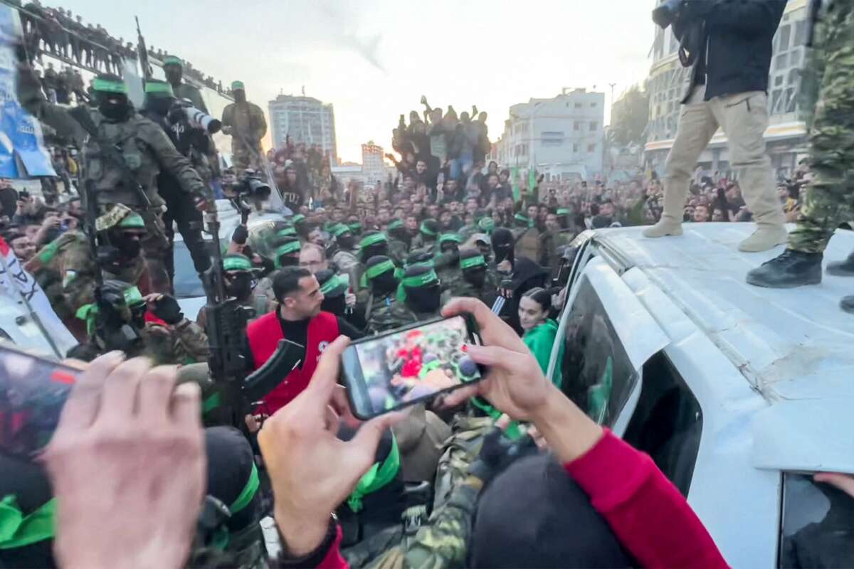 This screen grab taken from AFPTV shows one of the Israeli hostages exiting a vehicle to be handed over to the International Committee of the Red Cross during the hostage-prisoner exchange operation in Saraya Square in western Gaza City on January 19, 2025.