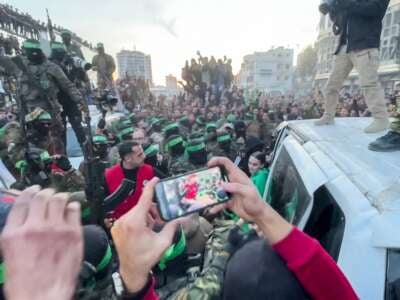 This screen grab taken from AFPTV shows one of the Israeli hostages exiting a vehicle to be handed over to the International Committee of the Red Cross during the hostage-prisoner exchange operation in Saraya Square in western Gaza City on January 19, 2025.