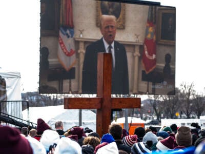 People attending the annual anti-abortion March for Life rally watch a pre-taped video recording of U.S. President Donald Trump on the National Mall on January 24, 2025, in Washington, D.C.