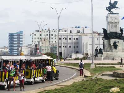 A children's train used as public transport for tourists and locals, along the Malecón in Havana, Cuba.