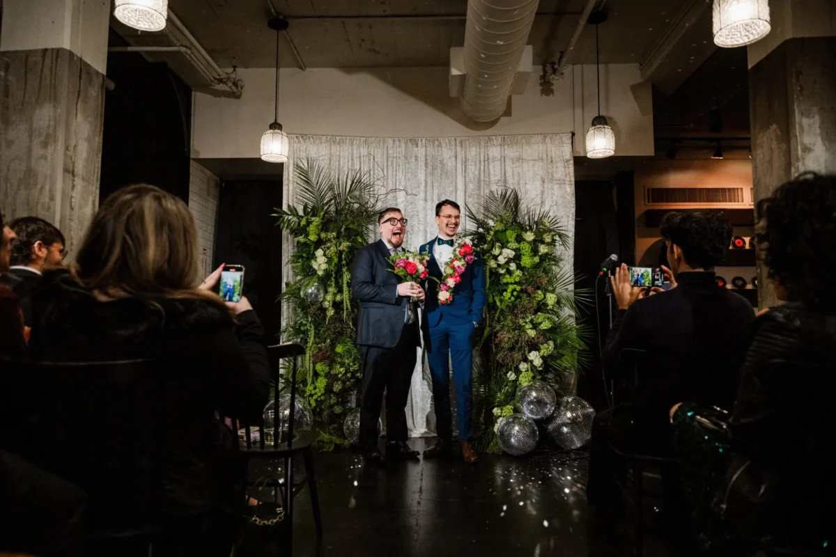 Quintin Marcus, left, and Marcelo Castro-Alpízar get married at a Queerly Beloved group wedding event on January 5, 2025, in Cambridge, Massachusetts.