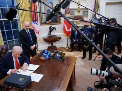 President Donald Trump, joined by Commerce Secretary nominee Howard Lutnick, signs a series of executive orders.