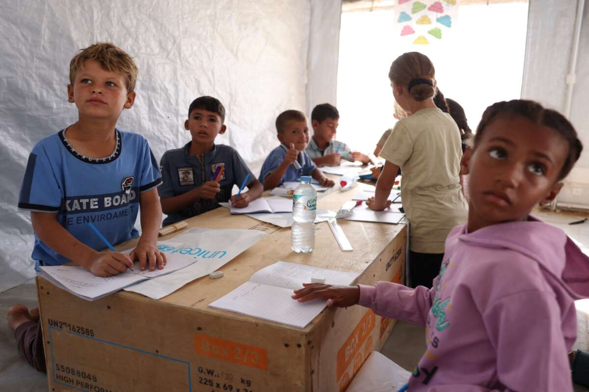 Palestinian school children attend a lesson at a temporary educational centre under the supervision and funding of UNICEF in Khan Yunis in the southern Gaza Strip, on September 19, 2024, amid the ongoing war between Israel and the Palestinian Hamas movement.