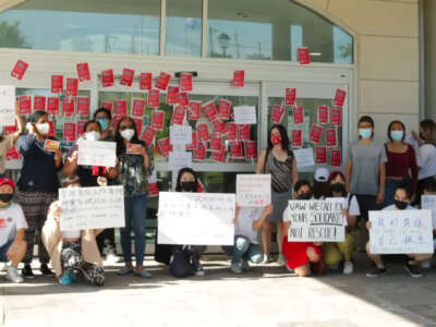 Community members rally in support of Asian massage workers, near Toronto, Ontario, in 2021. Some community members' faces have been anonymized to protect their privacy.