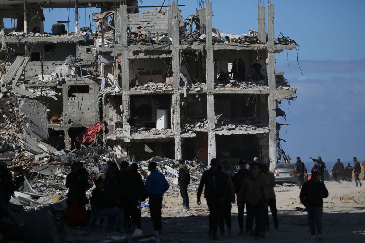 Palestinians search building rubble in a ruined neighborhood of Gaza's southern city of Rafah on January 20, 2025, as residents return following a ceasefire deal a day earlier between Israel and the Palestinian Hamas group.