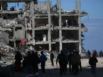 Palestinians search building rubble in a ruined neighborhood of Gaza's southern city of Rafah on January 20, 2025, as residents return following a ceasefire deal a day earlier between Israel and the Palestinian Hamas group.