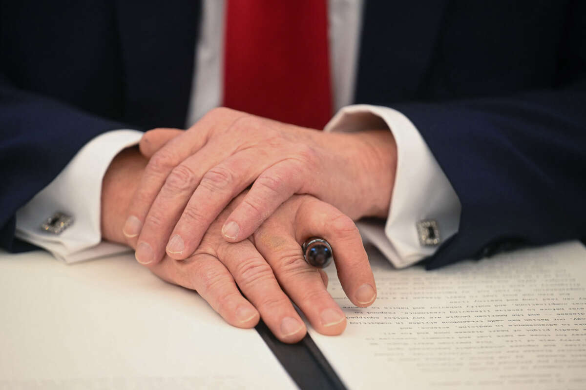 President Donald Trump holds a marker as he signs an executive order in the Oval Office of the White House on February 3, 2025, in Washington, D.C.