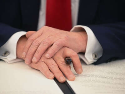 President Donald Trump holds a marker as he signs an executive order in the Oval Office of the White House on February 3, 2025, in Washington, D.C.