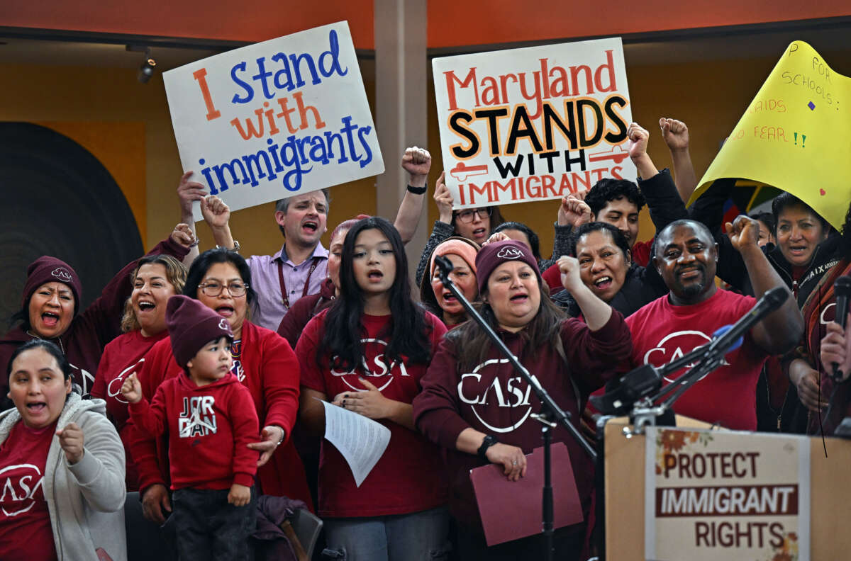 A group of immigrant supporters cheer with the news that a favorable ruling had occurred regarding immigrant birthright status, at the CASA Multicultural Center in Hyattsville, Maryland, on February 5, 2025.