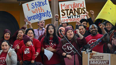 A group of immigrant supporters cheer with the news that a favorable ruling had occurred regarding immigrant birthright status, at the CASA Multicultural Center in Hyattsville, Maryland, on February 5, 2025.