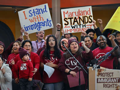 A group of immigrant supporters cheer with the news that a favorable ruling had occurred regarding immigrant birthright status, at the CASA Multicultural Center in Hyattsville, Maryland, on February 5, 2025.