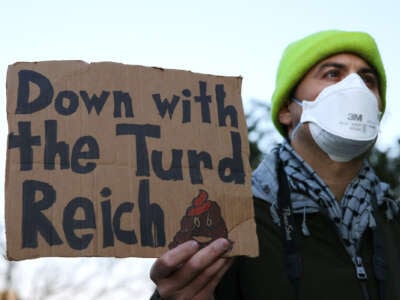 Demonstrators gather outside of the Office of Personnel Management to protest federal layoffs and demand the termination of Elon Musk and his proposed "Department of Government Efficiency," in Washington, D.C., on February 7, 2025.