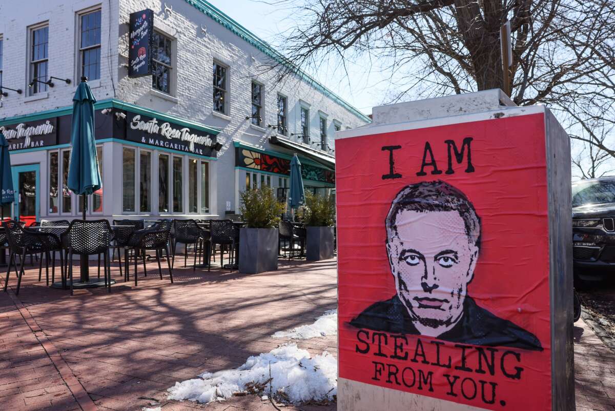 An "I Am Stealing From You" Elon Musk poster is seen at the U.S. Capitol on February 14, 2025, in Washington, D.C.