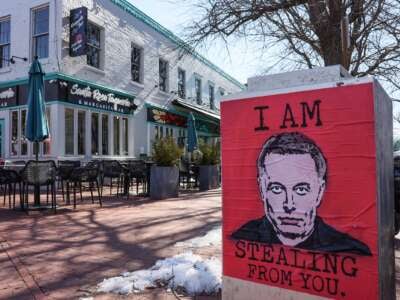 An "I Am Stealing From You" Elon Musk poster is seen at the U.S. Capitol on February 14, 2025, in Washington, D.C.