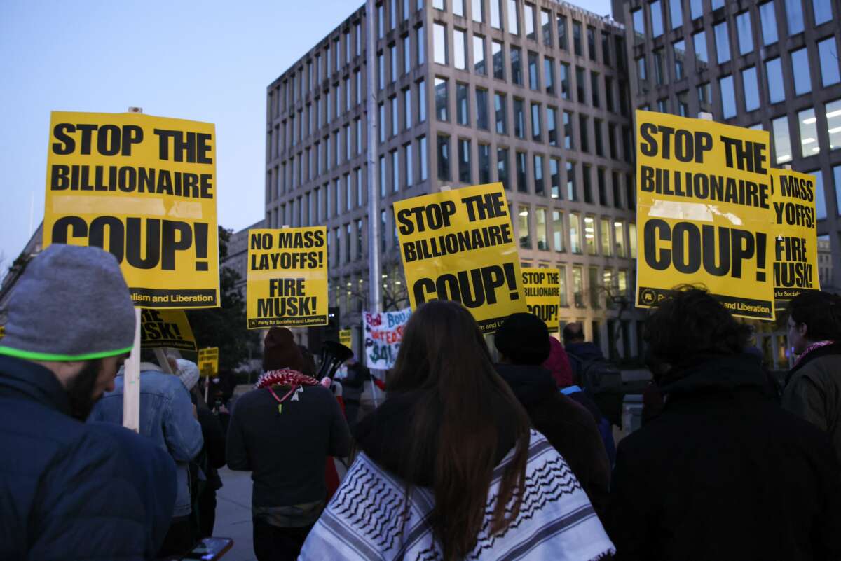 Demonstrators gather outside of the Office of Personnel Management to protest federal layoffs and demand the termination of Elon Musk from the "Department of Government Efficiency" (DOGE) in Washington, D.C., on February 7, 2025.