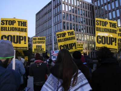 Demonstrators gather outside of the Office of Personnel Management to protest federal layoffs and demand the termination of Elon Musk from the "Department of Government Efficiency" (DOGE) in Washington, D.C., on February 7, 2025.