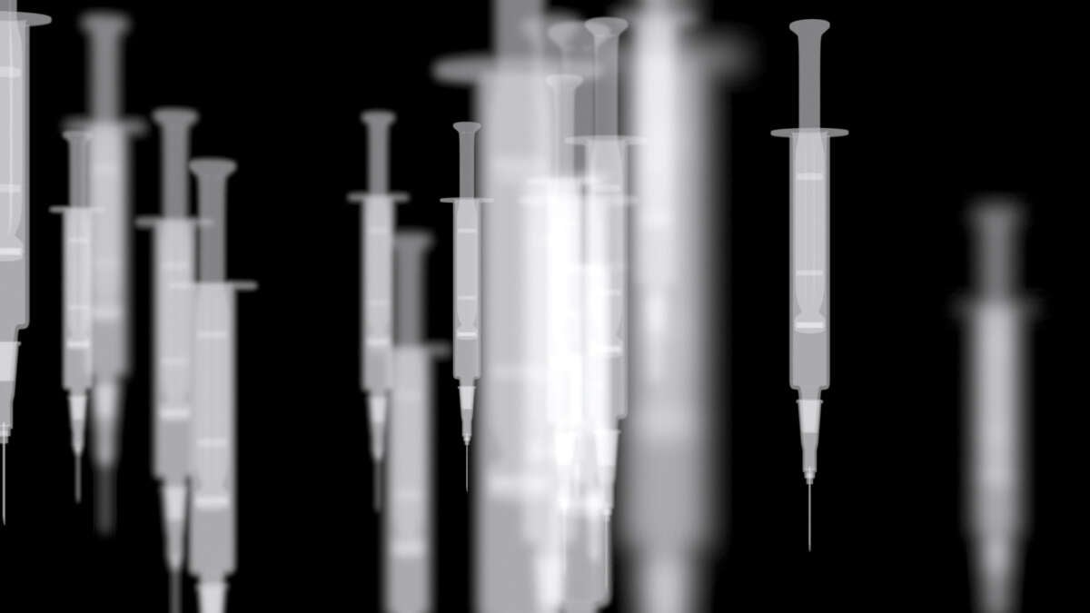 Syringes over a dark background