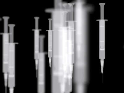 Syringes over a dark background