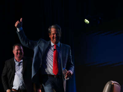 Georgia Gov. Brian Kemp gives the thumbs down to as he exits the stage after speaking during The Gathering conservative conference hosted and moderated by talk radio host Erick Erickson (left) at the Grand Hyatt hotel on August 18, 2023, in Atlanta, Georgia.