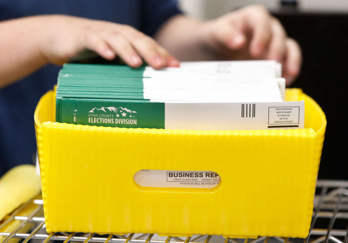 An election worker stacks various ballots envelopes so they can be opened and counted at the election office on October 26, 2020, in Provo, Utah.