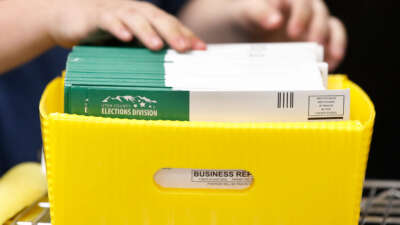 An election worker stacks various ballots envelopes so they can be opened and counted at the election office on October 26, 2020, in Provo, Utah.