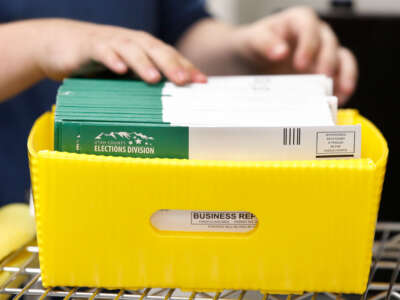 An election worker stacks various ballots envelopes so they can be opened and counted at the election office on October 26, 2020, in Provo, Utah.