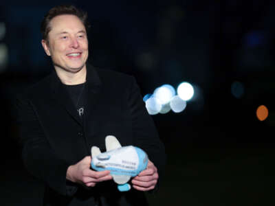 Tesla and SpaceX CEO Elon Musk holds up an Air Force One stuffed toy as he walks from the presidential helicopter Marine One on the South Lawn of the White House on February 19, 2025, in Washington, D.C.