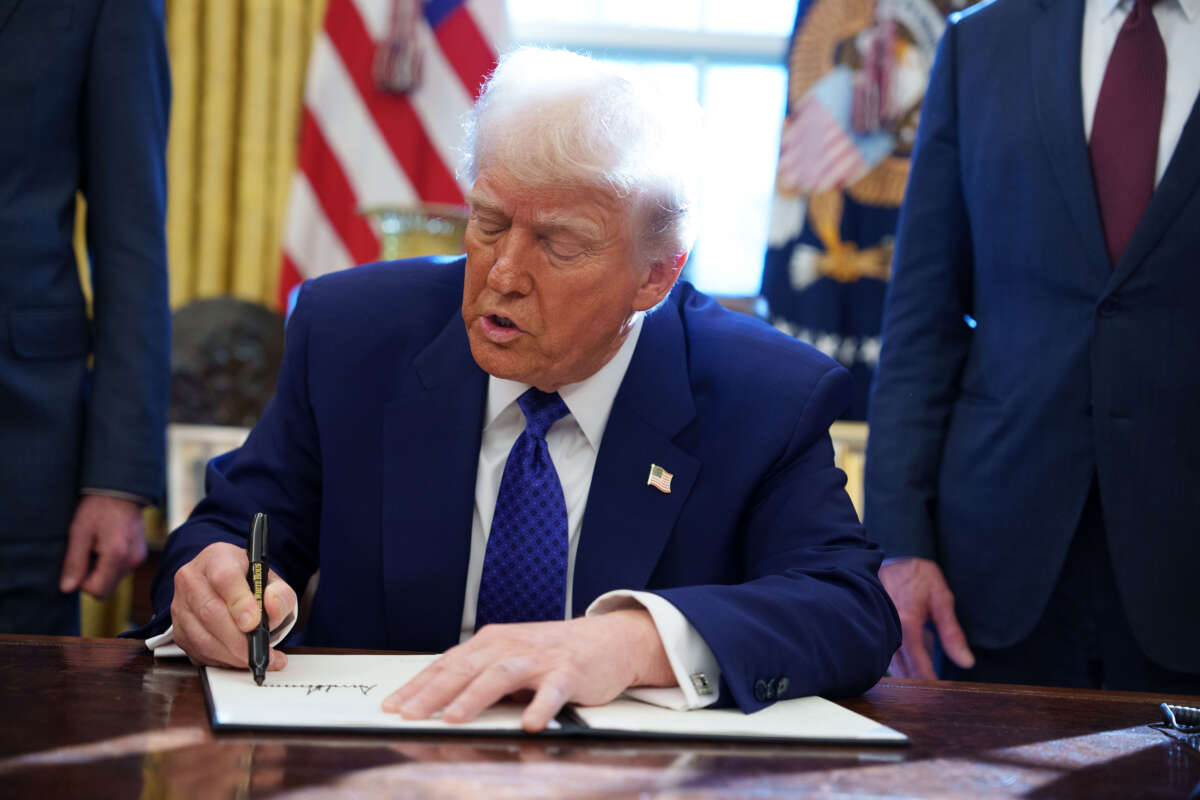 President Donald Trump signs an executive order establishing the Energy Dominance Council led by Secretary of the Interior Doug Burgum in the Oval Office at the White House on February 14, 2025, in Washington, D.C.