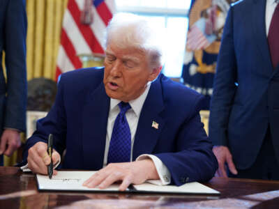 President Donald Trump signs an executive order establishing the Energy Dominance Council led by Secretary of the Interior Doug Burgum in the Oval Office at the White House on February 14, 2025, in Washington, D.C.