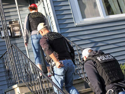 ICE agents make their way into a house on September 25, 2019, in Revere, Massachusetts.