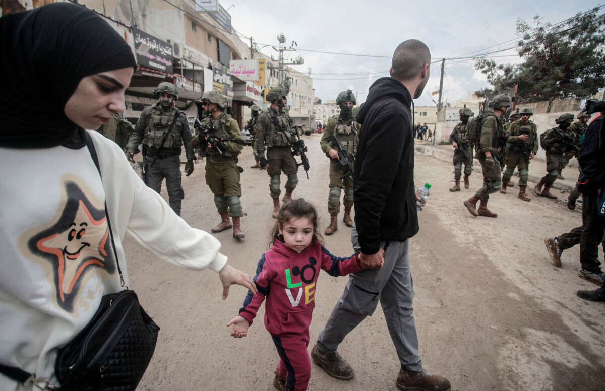 Palestinian families leave their destroyed homes after being denied entry to the Jenin refugee camp near the West Bank city of Jenin on February 19, 2025.