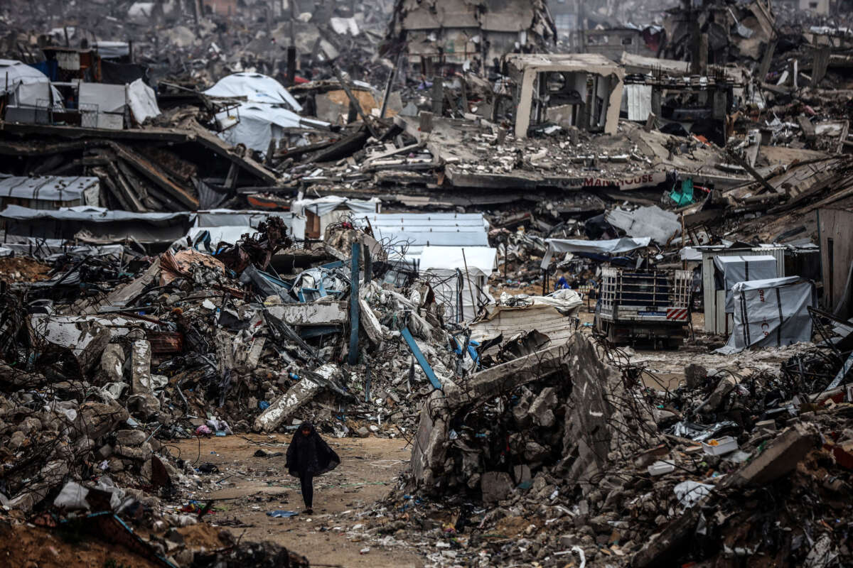 Palestinians walk past tents lining the streets amid the rubble of destroyed buildings in Jabalia, in the northern Gaza Strip, on February 21, 2025.