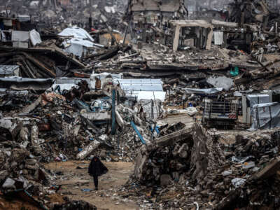 Palestinians walk past tents lining the streets amid the rubble of destroyed buildings in Jabalia, in the northern Gaza Strip, on February 21, 2025.