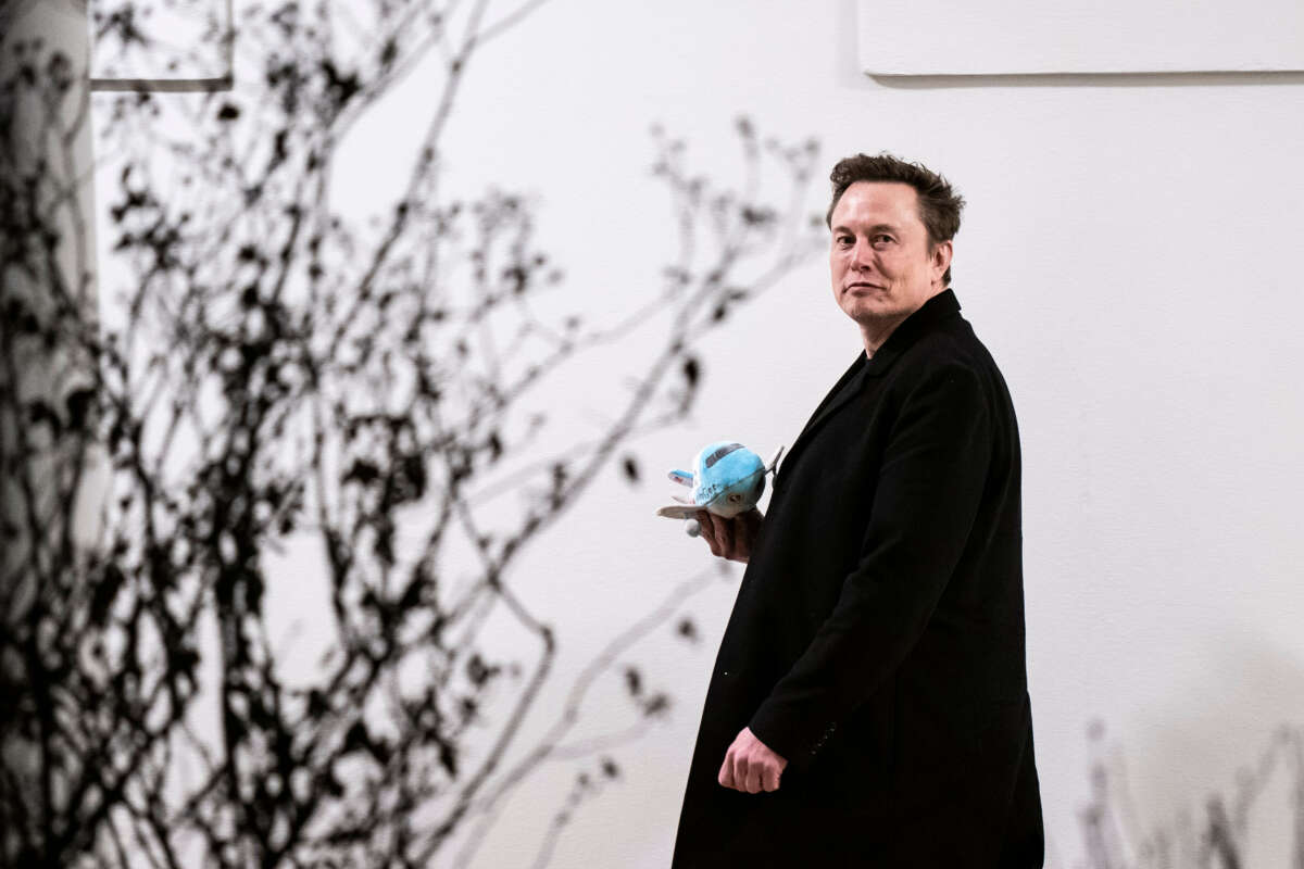 Elon Musk carries a stuffed Air Force One as he walks back to the West Wing along the colonnade after returning to the White House on Marine One on February 19, 2025, in Washington, D.C.